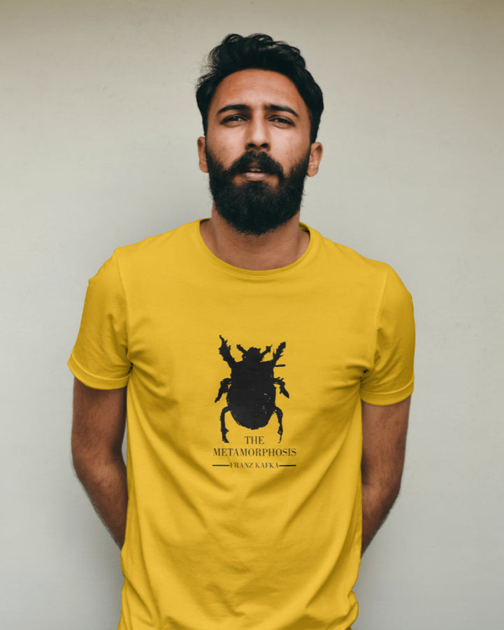 Yellow unisex t-shirt featuring a black silhouette of a beetle and text for 'The Metamorphosis' by Franz Kafka.