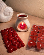 Bulgarian Rose Heart Diffuser Gift Set with red heart candles and a seashell on a wooden surface.