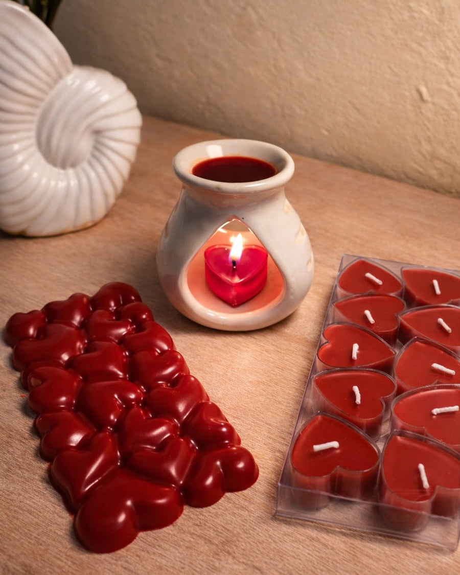 Bulgarian Rose Heart Diffuser Gift Set with red heart candles and a seashell on a wooden surface.