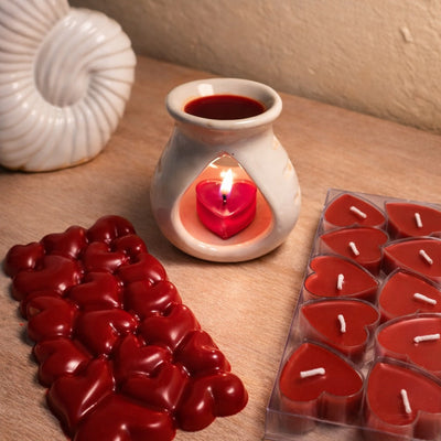 Bulgarian Rose Heart Diffuser Gift Set with red heart candles and a seashell on a wooden surface.