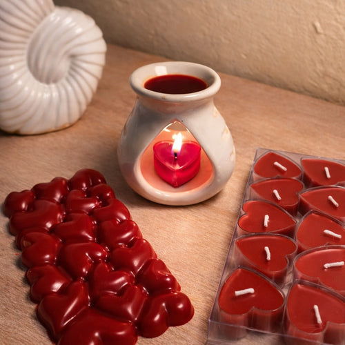Bulgarian Rose Heart Diffuser Gift Set with red heart candles and a seashell on a wooden surface.