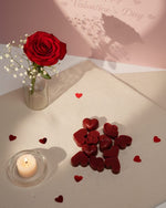 Bulgarian Rose Heart Diffuser Gift Set with rose, candle, and heart-shaped chocolates on a textured surface.