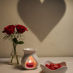 Bulgarian Rose Heart Diffuser Gift Set with red roses and heart-shaped wax melts, creating a romantic ambiance.