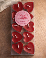 A set of ten red, heart-shaped tea light candles made of soy wax, presented in a clear plastic box.