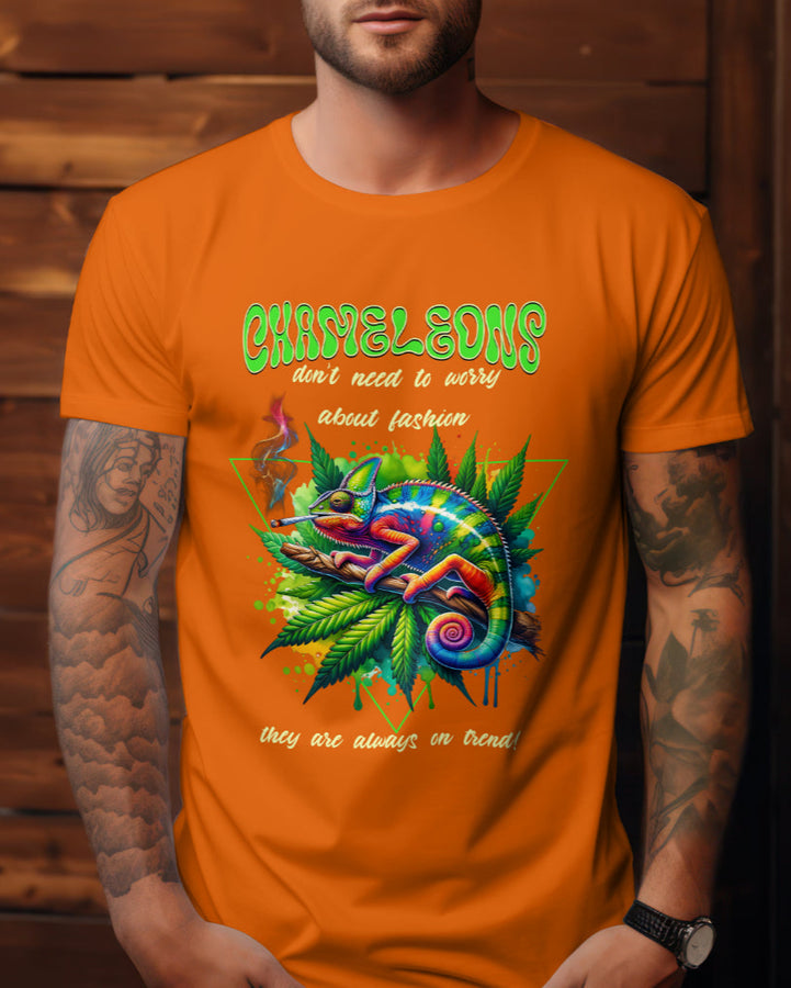 Orange t-shirt with a colorful chameleon relaxing on a branch with cannabis leaves, featuring text about fashion.