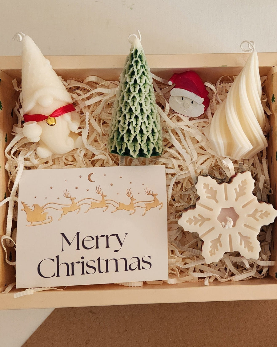 Christmas gift set featuring soy wax mould candles and cement art, including gnome, tree, Santa, and snowflake designs.
