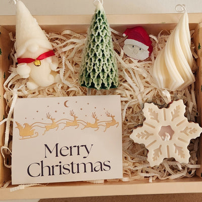 Christmas gift set featuring soy wax mould candles and cement art, including gnome, tree, Santa, and snowflake designs.