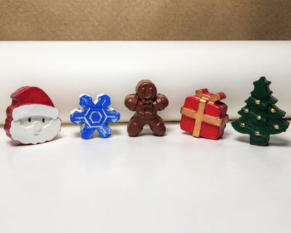 santa, snowflake, gingerbread, giftbox, christmas tree miniature cement art collection on display.