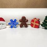Hand-painted miniature cement art Christmas figures including Santa, snowflake, gingerbread man, gift, and tree, perfect for festive decor.