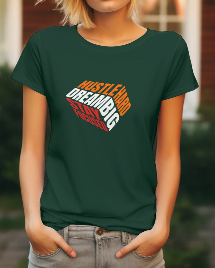 Front view of a dark green female t-shirt with a 'Hustle Hard Dream Big Stay Focused' graphic design.