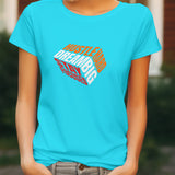 Front view of a cyan t-shirt with 'Hustle Hard Dream Big Stay Focused' graphic design.