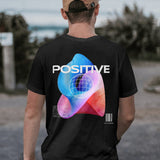 Back view of a black unisex t-shirt with a 'Cosmic Positive Vibes' psychedelic graphic and globe design.