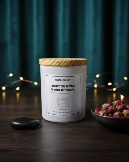 Candle with wooden lid on a dark surface with decorative elements