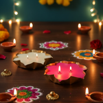 Set of 2 lotus urli soy wax candles, one white and one pink, arranged with diyas and rangoli for Diwali.