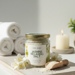 Blue Honey Jasmine Relaxing Salt for body and feet in a glass jar with a wooden scoop.