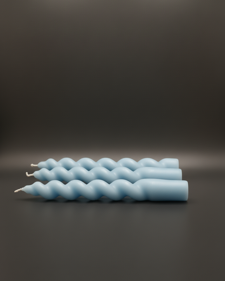 Three blue textured candles on a dark background