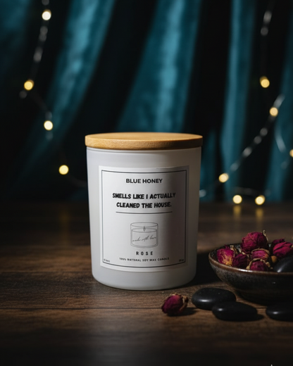 Candle with a wooden lid on a dark surface with decorative elements