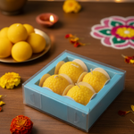 Motichoor Laddoo floating candles presented in a light blue gift box, perfect for Diwali gifting.