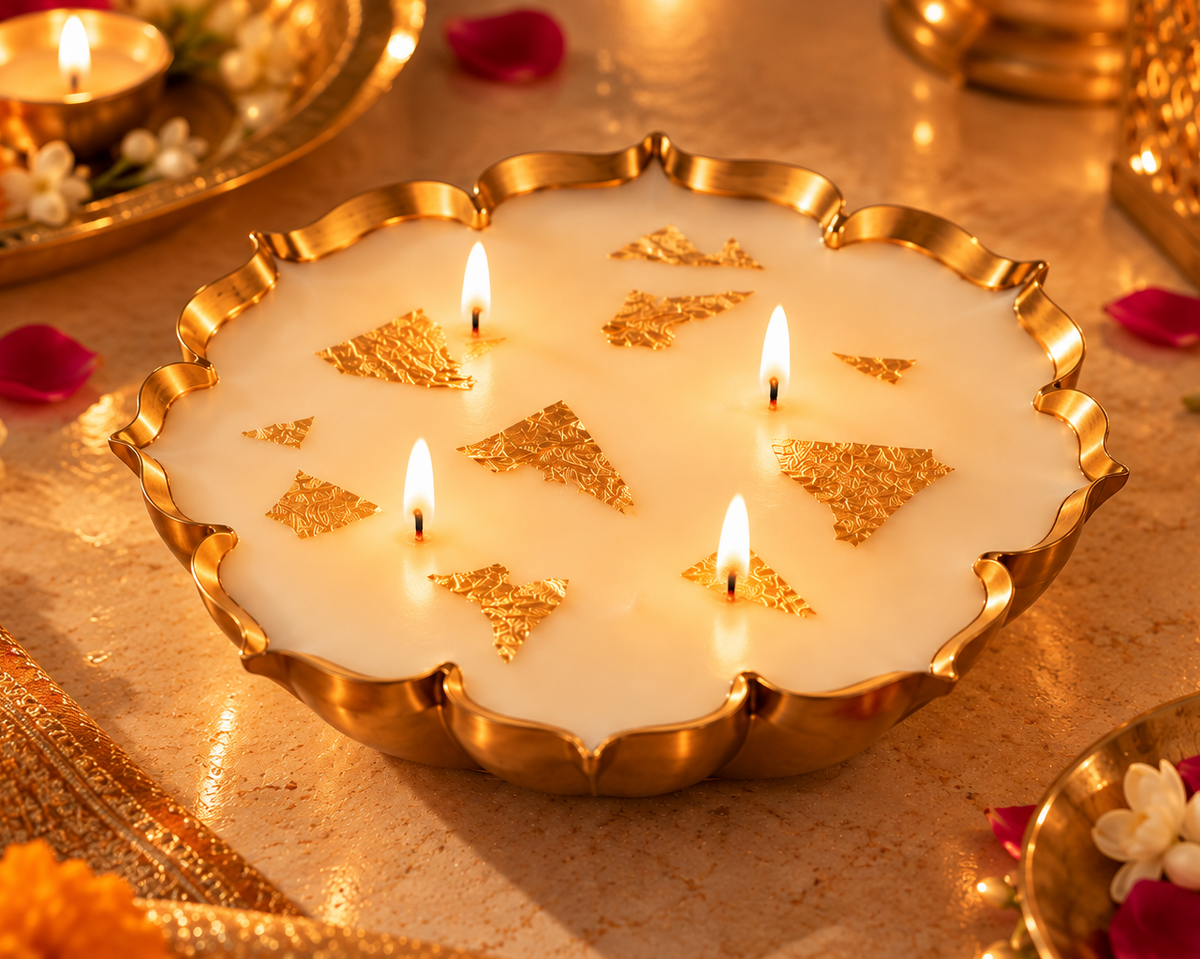 Four-wick gold leaf urli candle lit as a Diwali centrepiece with marigolds, jasmine and rose petals