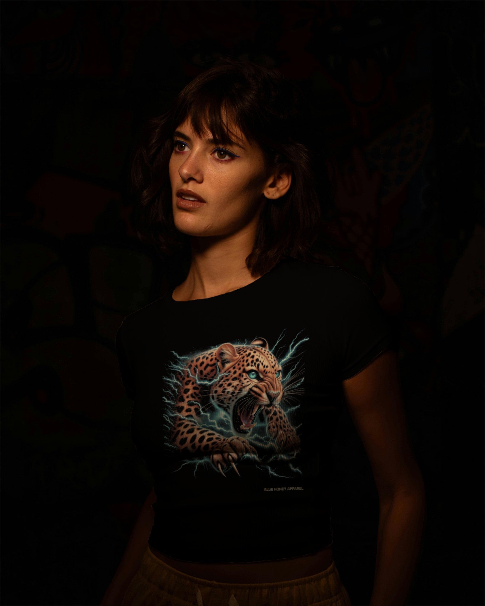 A female model wearing "Electrifying Leopard Graphical" half-sleeve black t-shirt