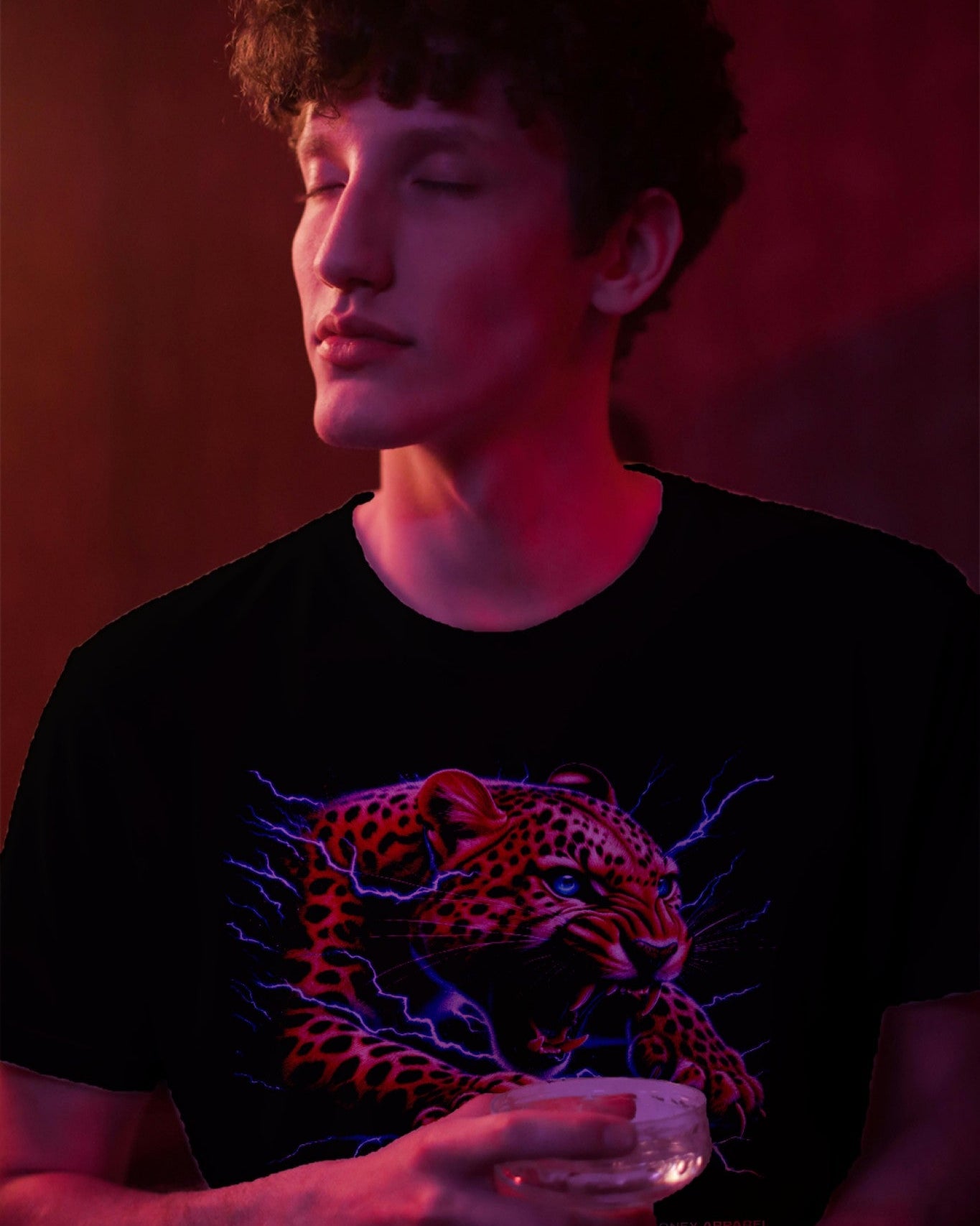 A male model wearing "Electrifying Leopard Graphical" half-sleeve black t-shirt