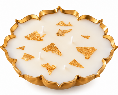 Blue Honey sandalwood urli candle in a 5.5 inch gold scalloped bowl with gold leaf and four wicks, on a white background