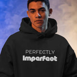 Front view of a black Perfectly Imperfect heavyweight oversized hooded sweatshirt with white typography.