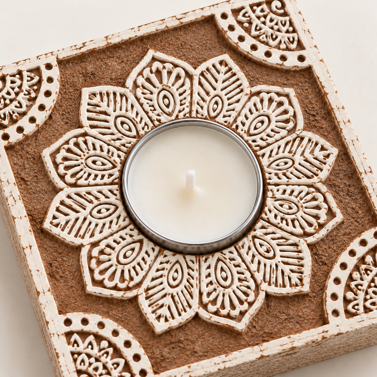 Close-up of the hand block-printed ivory mandala around a soy wax tealight