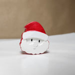 Hand-painted miniature cement Santa Claus fridge magnet, a festive holiday decoration.