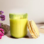 Lime green Ribbed Radiance scented jar candle with a gold lid, featuring a ribbed glass design.