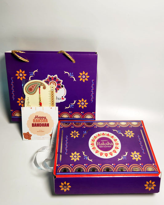 Decorative gift box with 'Happy Raksha Bandhan' tag on a white background