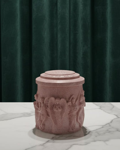 Pink decorative candle jar on a marble surface with a green curtain background