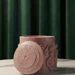 Pink Jesmonite Renaissance Relic Scrolled candle vessel with intricate scrollwork and lid detail.