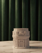 The Grand Pavilion Architectural Jesmonite Candle Jar in white, showcasing intricate building details, presented front-on.