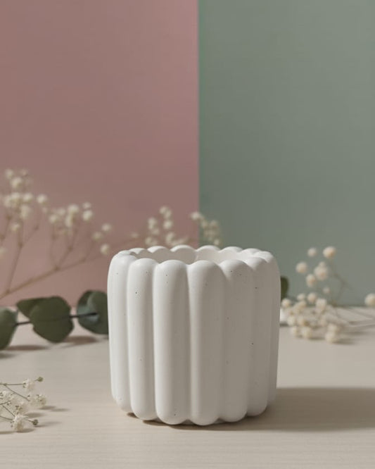 White textured candle on a neutral background