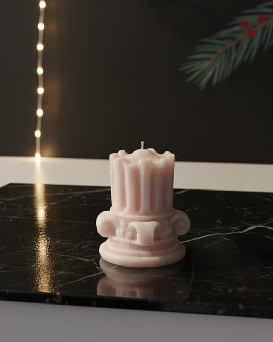 Decorative candle on a black surface with geometric decorations and lights in the background