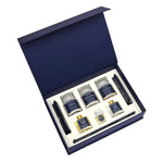 An open navy blue presentation gift box containing a set of six grooming or fragrance products arranged on a white insert, photographed on a clean white background.