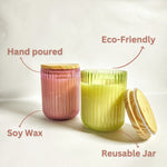 Two scented ribbed glass jar candles, one pink and one green, highlighting hand-poured soy wax and reusable jars.