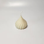 A white, swirl-shaped modak candle, perfect for Ganesh Chaturthi or as a unique gift.