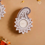 Handcrafted wooden carved tealight holder with intricate paisley design, holding a white tealight candle.