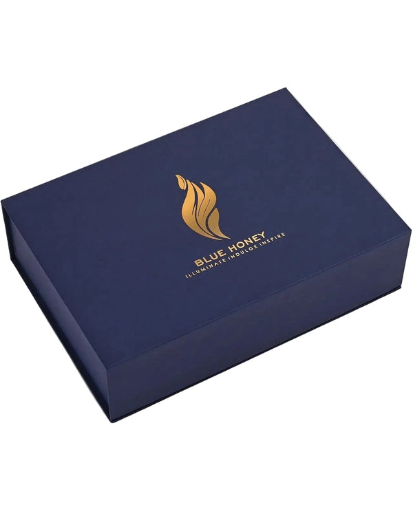 A dark blue rectangular gift box with a gold honeycomb logo and the text 'BLUE HONEY' on the lid, shown at an angle on a white background.