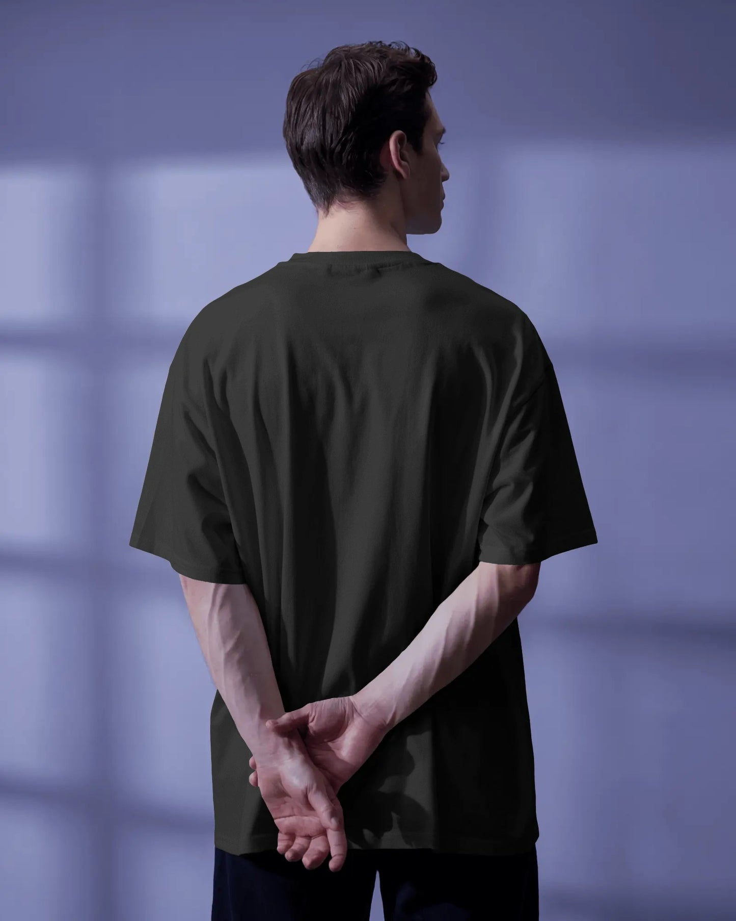 back view of a white model standing wearing the black Thalassophile tshirt 