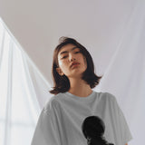 Oversized white Diljit Dosanjh 'Diluminati' t-shirt with a cosmic graphic design on the front.