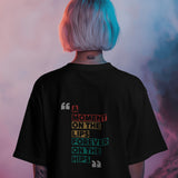 Back view of a black unisex oversized t-shirt with 'A Moment on the Lips, Forever on the Hips' text.