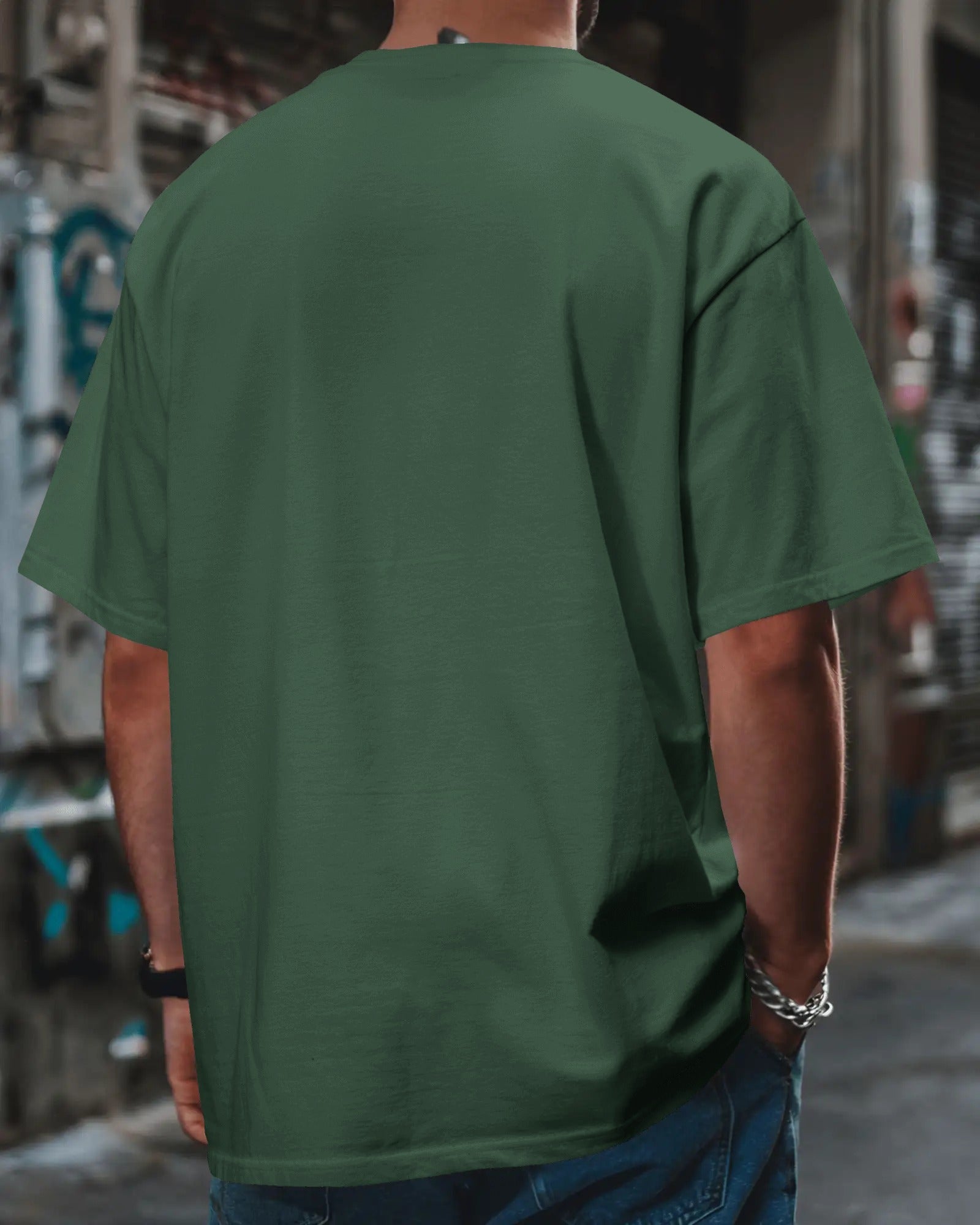 plain back view of a male model wearing an oversized Bottle Green Anthophile tshirt