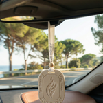 Eco-friendly Blue Honey car aroma tag hanging from a rearview mirror, featuring a flame design.