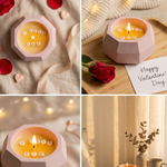 Baby pink concrete jar candle with "I Love You" hidden message, lit flame, and rose petals.