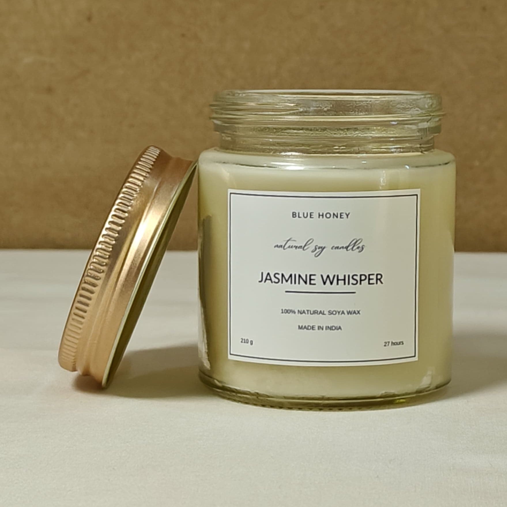 blue honey jasmine scented  soy wax candle mason jar with lid on side