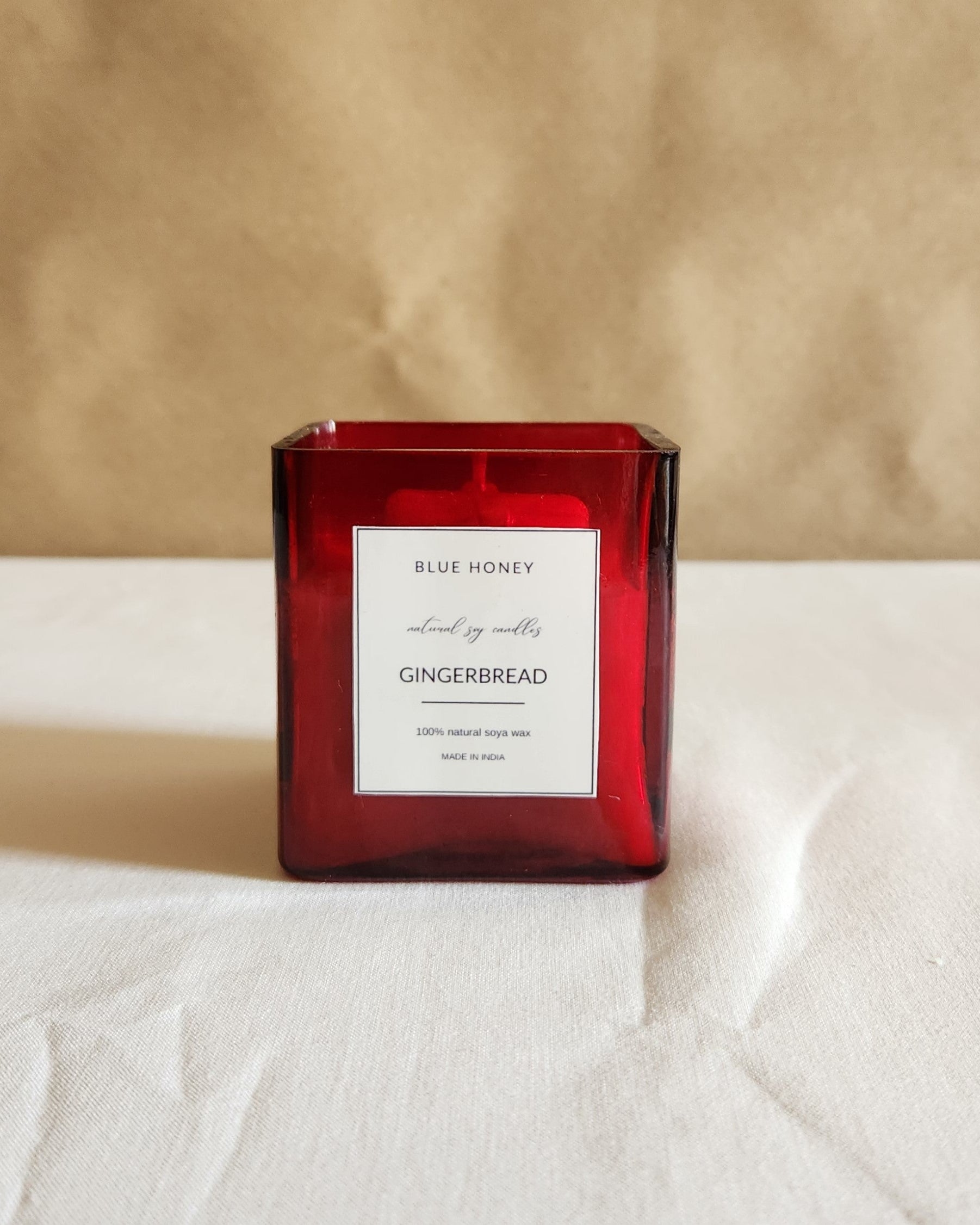 blue honey red cuboid shaped glass jar candle label reads Ginger bread.