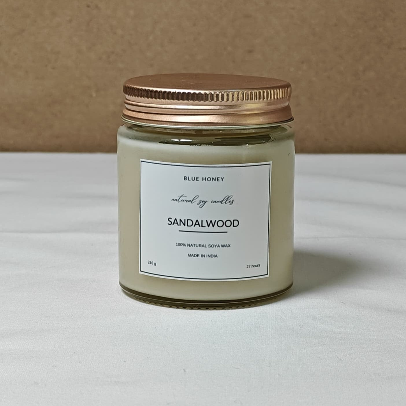 Mason jar with gold lid, label reads Sandalwood scented.